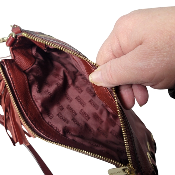 Michael Kors red leather clutch with grommets and tassels